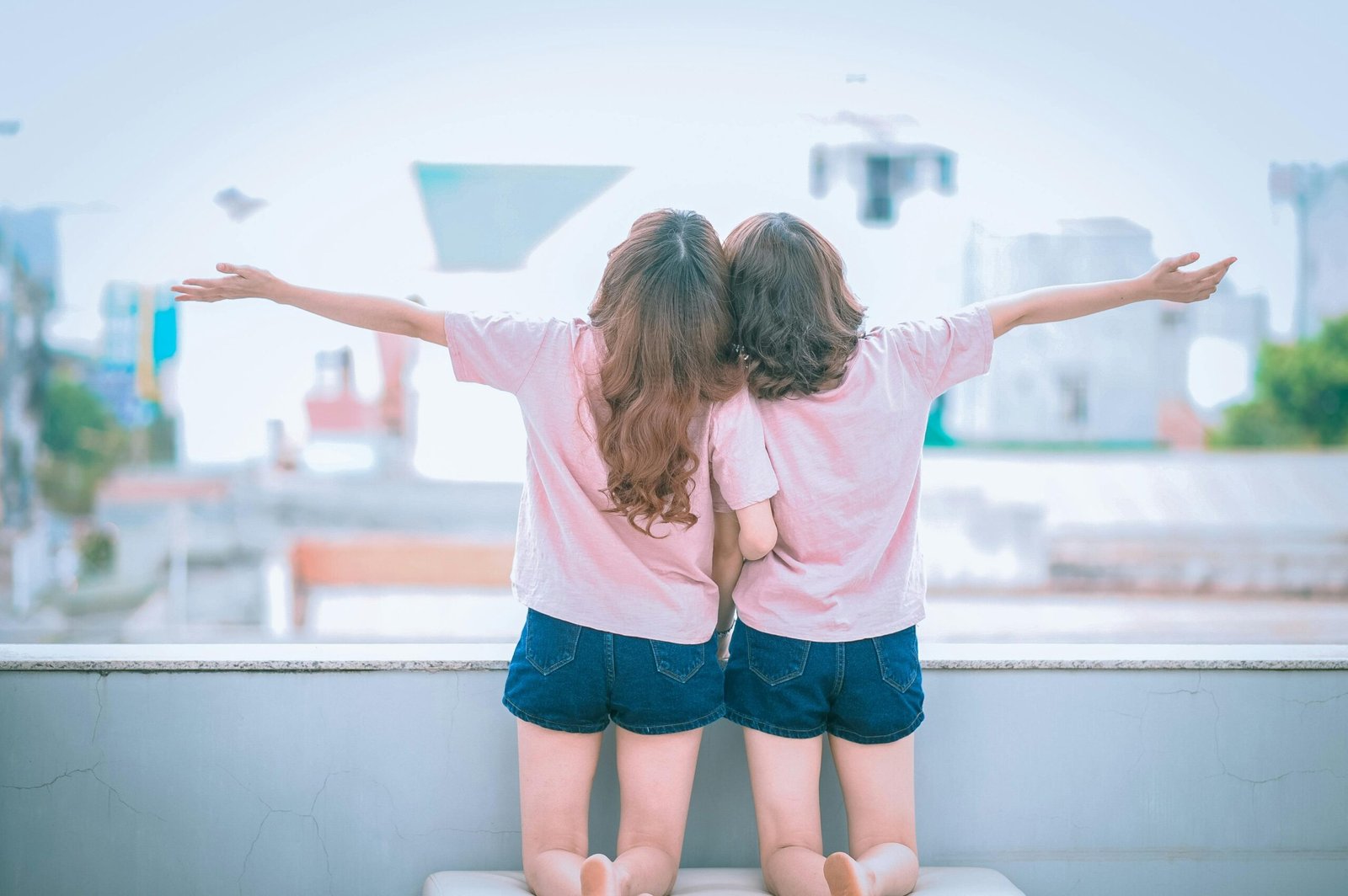 Two young sisters enjoying a sunny day, capturing the essence of carefree sibling love.